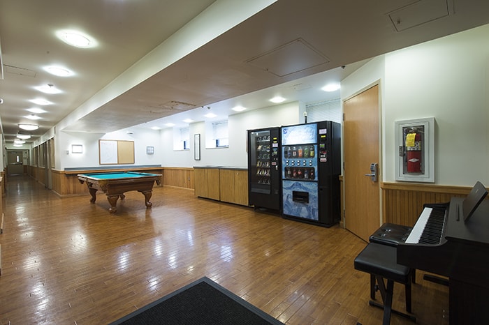 Henderson House Game Room - pool table vending machines and a piano